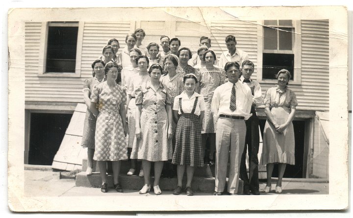 0240.jpg - Sugar Creek Young Adult Sunday School Class.  1941c  Taken in front of Surgar Creek Church, Wayland, IAFar Back:  Josephine Richard; Back row left:  Cathryn Nebel, ???, Rachel Graber, Mable Roth, ???, Noah Underhaher; Third Row:  ???, Barbara Wenger, ? Eigsti, Edith Roth; Second Row:  Stella Roth, Inez Nebel, ???, Dennis Graber, ??? end; Front row:  ???, Ruth Miller, Edna Reschly, Maurice Kraybill,