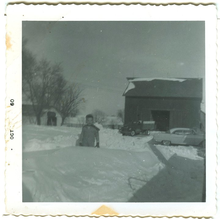 1035.jpg - Reynolds with a big snow!  1960   Pink/white pontiac in the background.