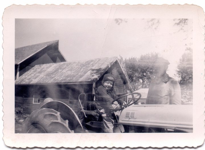 1509.jpg - Fred Roth on a tractor with Ray Roth.  1949c