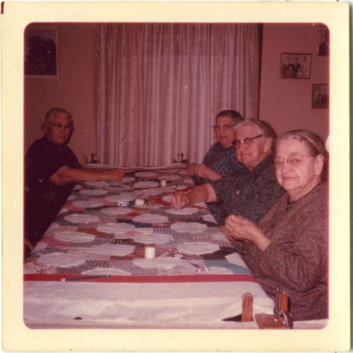 0413.jpg - Quilting at Edna's house.  Rt to left:  Katie Reschly, Lydia Roth [mother of Gladys Widmer], Eva Reschly, and Edith Boese's mother from NE.  1968  Lynn's necktie quilt.