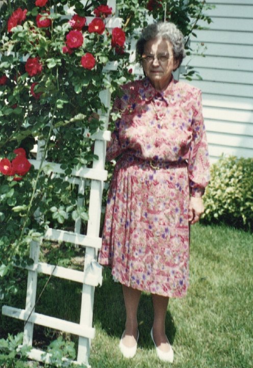 1882.jpg - Edna Roth by her rose arbor in Olds, IA.