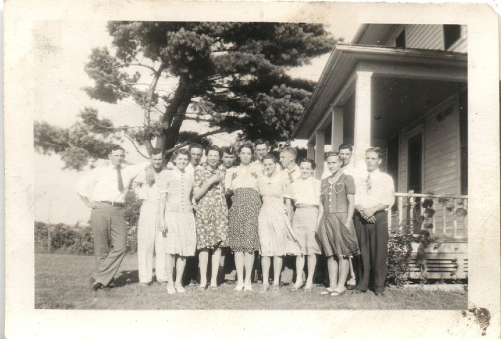 0096.jpg - Young Sugar Creek Adults:  1940c  Front Left:  Alberta Boese, Aldine & Alice Eichelberger, Irene & Edna Reschly, Dorothy Roth; back left:  Bill Roth, Orval Miller, Henny Roth, Galen Widmer, Ray Roth, Marlin Wyse, Laverne Blosser,  ? Kraybill.  Taken at the Roth place on Hwy 78unknown