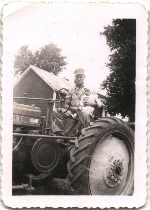 0217.jpg - Ray holding Fred on a John Deere.