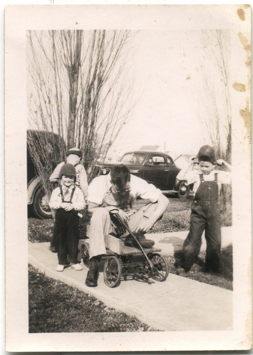 0271.jpg - Ray on old wagon with kids.