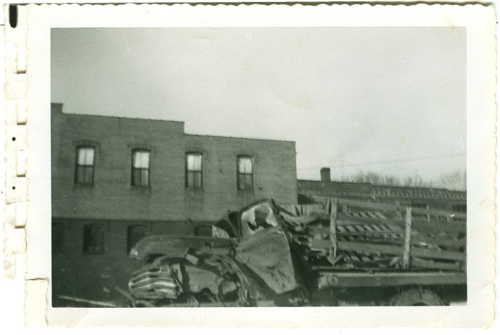 1231.jpg - Wrecked 54 Chevy 1 ton dualie truck driven by Levi Roth with Ray Roth as passenger.  They were taking a load of Easter lambs to market in Waterloo, IA.  A semi jack-knifed on ice, and the trailer slammed into them.  Levi was pinned inside and Ray was thrown from the truck.  Gas leaked from the tank and a fire started under the truck where Levi was.  George Widmer came by in a semi and put out the fire with his fire extingisher.  This occurred 1/2 mi north of Coralville Lake on old 218.  The truck was in a wrecking yard in Iowa City, IA.  1956