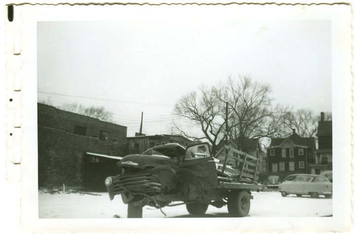 1232.jpg - Wrecked 54 Chevy 1 ton dualie truck driven by Levi Roth with Ray Roth as passenger.  They were taking a load of Easter lambs to market in Waterloo, IA.  A semi jack-knifed on ice, and the trailer slammed into them.  Levi was pinned inside and Ray was thrown from the truck.  Gas leaked from the tank and a fire started under the truck where Levi was.  George Widmer came by in a semi and put out the fire with his fire extingisher.  This occurred 1/2 mi north of Coralville Lake on old 218.  The truck was in a wrecking yard in Iowa City, IA.  1956