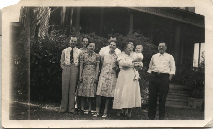 0202.jpg - William & Katie Reschly Family.  1939c  left:  Harold, Ruth, Edna, Irene, Floyd & Hazel [back], Katie holding Edward, William Reschly.  Irene made the dress she's wearing.