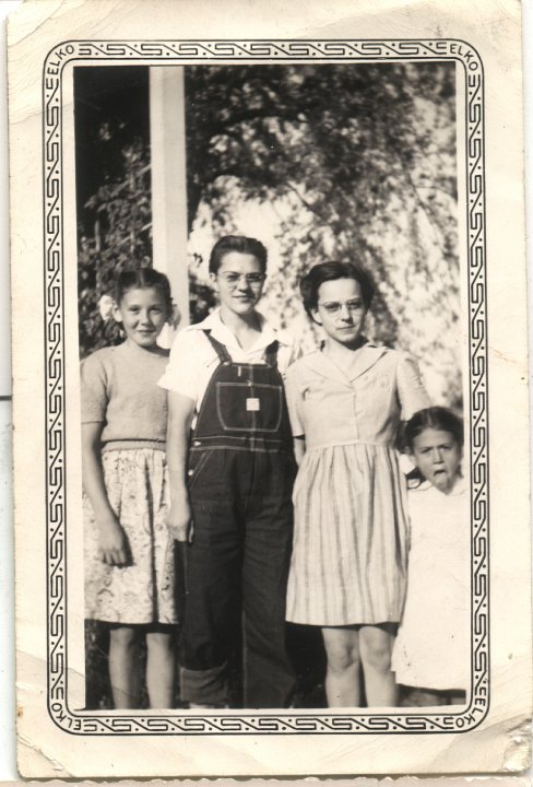 0254.jpg - Irene & Edna Reschly [center] with Susie & Kathy Reschly [Fort] [Joseph & Anna's children].  1938c  Taken at Uncle Joe's house in Noble, IA   Irene wearing overalls, forbidden by her mother.