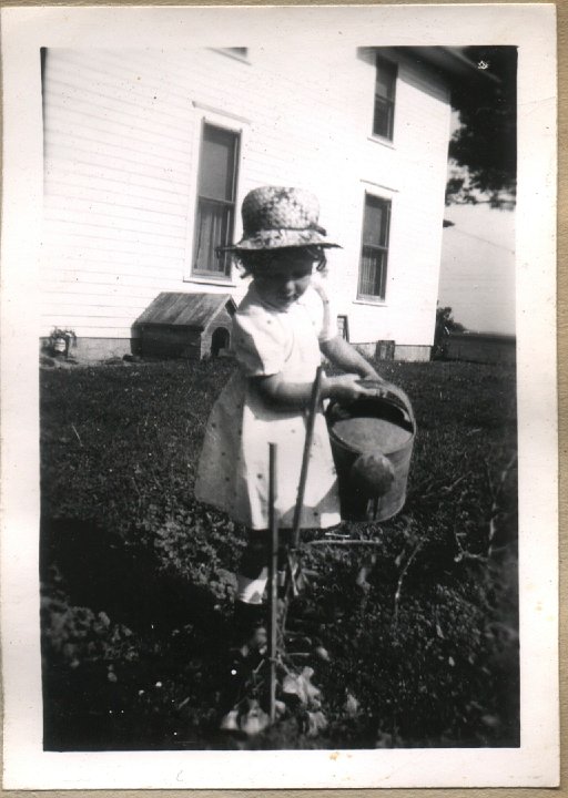 0377.jpg - Louise Reschly watering plant.  1946c  booklet 6 of 10.