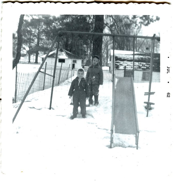 1105.jpg - Lamar Roth & unknown.  Swinging in the snow. 1962